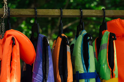 Close-up of multi colored clothes hanging on rack at market