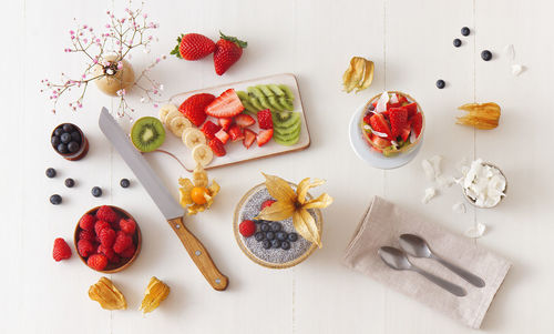 Chia seeds pudding dessert with summer berries, strawberries, raspberries, kiwi directly above table