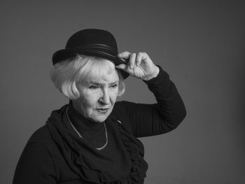 Close-up portrait of woman against white background