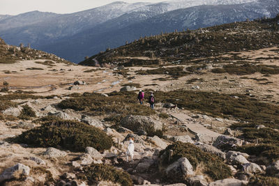 People walking on rocky mountains