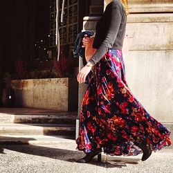 Full length of young woman standing by railing