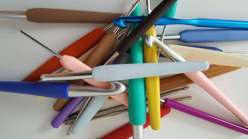 Directly above shot of knitting needles on table