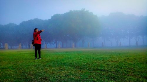 Full length of man standing on field against sky