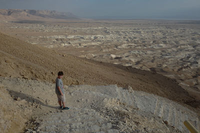High angle view of boy standing on landscape