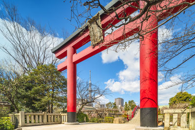 Low angle view of red and trees against sky