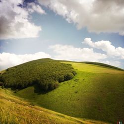 Scenic view of landscape against cloudy sky