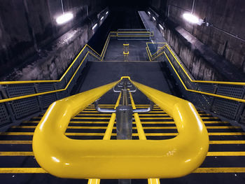 High angle view of empty yellow steps in underground subway station