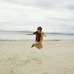 Full length of man on beach against sky