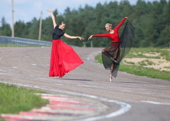 Full length of woman standing on road