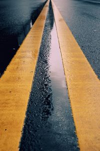 High angle view of zebra crossing on road by water