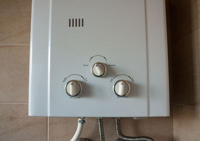 Close-up of electrical equipment mounted on wall at home