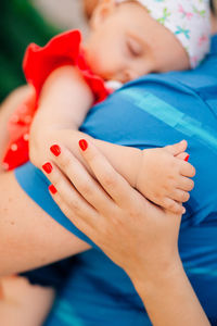 Close-up of woman with daughter resting on shoulder