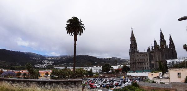 Panoramic view of buildings in city against sky