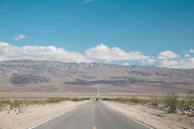 Road amidst landscape against sky