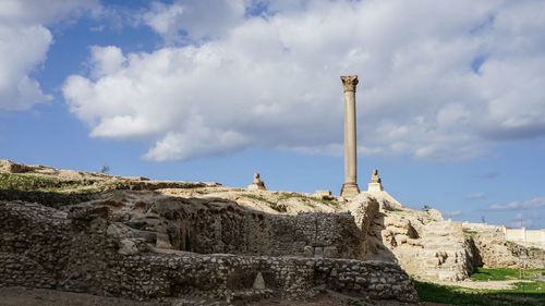 Alexandria egypt pompey's pillar from far view with cloudy blue sky 