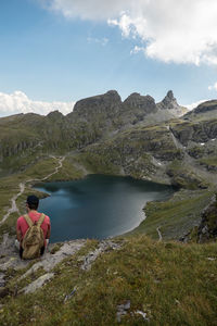 Rear view of man looking at lake