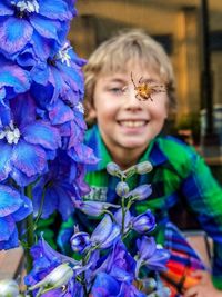 Portrait of smiling girl with purple flower