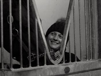 Portrait of smiling woman against window