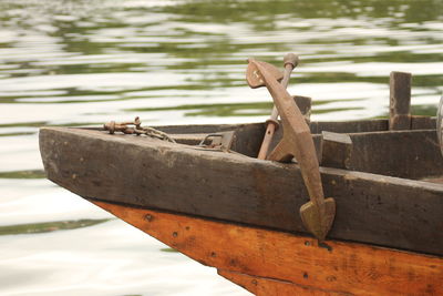 Close-up of boat moored on lake