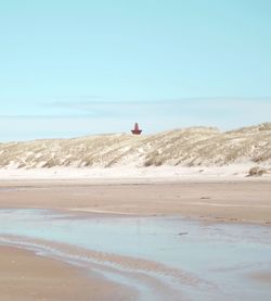 Scenic view of beach against clear sky