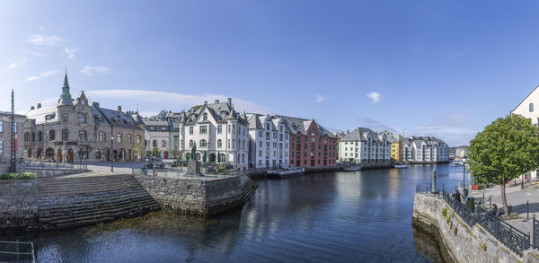 Buildings in city against blue sky