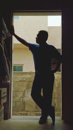 Full length of woman standing on railing