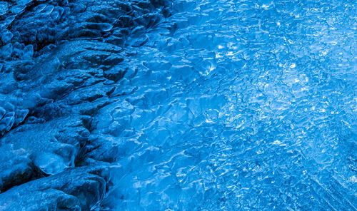Close up of frozen river. frozen water textures.