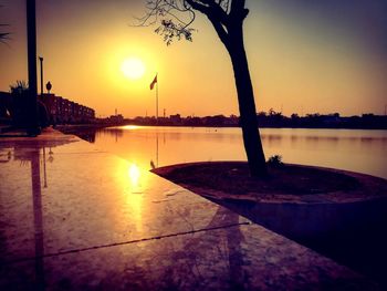 Scenic view of lake against clear sky during sunset