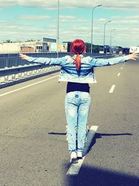 Rear view of a woman standing in the city