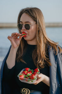 Portrait of young woman holding flower