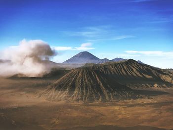 View of volcanic landscape against cloudy sky