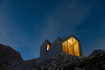 Low angle view of buildings against sky at night