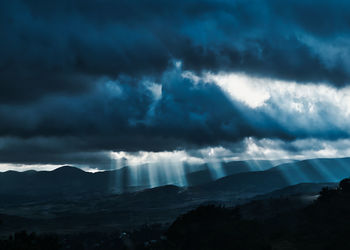 Sunlight streaming through storm clouds