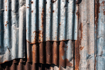 Old and rusty zinc sheet wall. vintage style metal sheet roof texture. pattern of old metal sheet. 