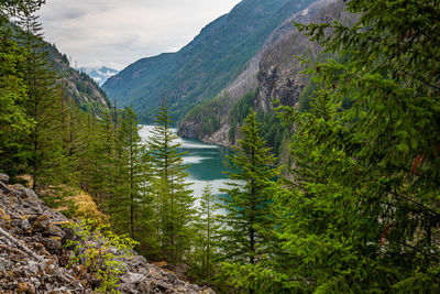 Scenic view of lake amidst mountains against sky