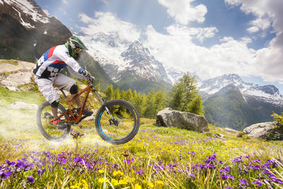 Bicycle parked on mountain range against sky