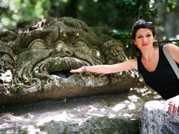 Portrait of young woman on rock