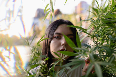 Portrait of young woman amidst plants