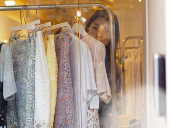 Midsection of woman in rack at store