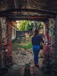 Rear view of woman standing in building