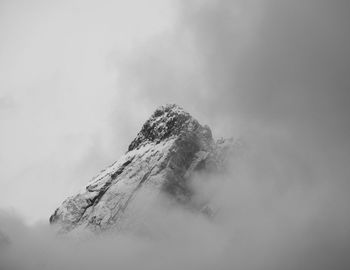 Peak of mountain between clouds
