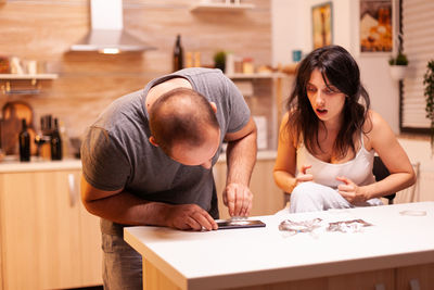 Side view of young woman working at table