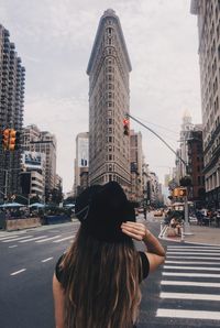 Rear view of woman on road in city