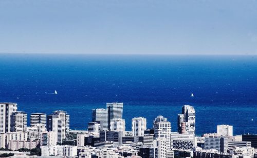 City skyline against blue sky