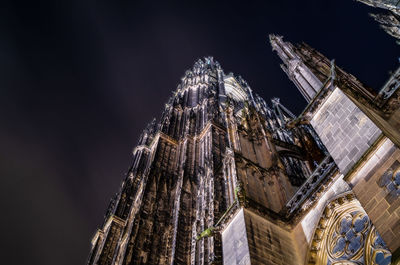 Low angle view of illuminated building against sky at night