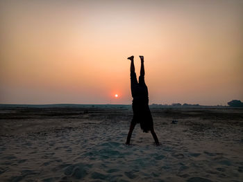 Full length of man at beach during sunset