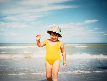 Full length of man standing on beach against sky