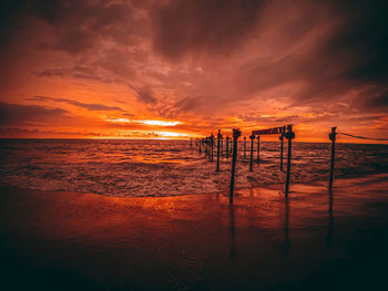 Scenic view of beach against sky during sunset