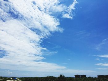 Scenic view of trees against cloudy sky