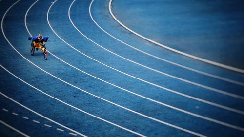 Handicap athlete practicing wheelchair race on sports track